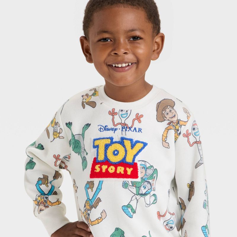 slide 2 of 4, Toddler Boys' Disney Toy Story Fleece Sweatshirt - Off-White 5T, 1 ct
