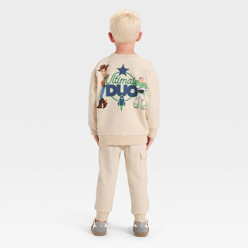 slide 2 of 4, Toddler Boys' 2pc Disney Toy Story Fleece Pullover and Bottom Set - Beige 2T, 2 ct