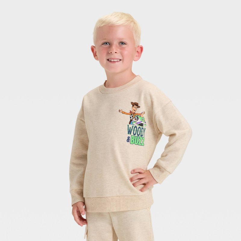 slide 3 of 4, Toddler Boys' 2pc Disney Toy Story Fleece Pullover and Bottom Set - Beige 2T, 2 ct