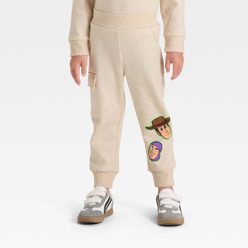 slide 4 of 4, Toddler Boys' 2pc Disney Toy Story Fleece Pullover and Bottom Set - Beige 2T, 2 ct
