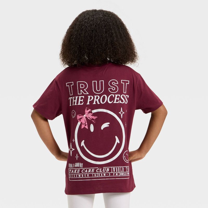 slide 1 of 4, Girls' SmileyWorld 'Trust The Process' Short Sleeve Oversized Front and Back Graphic T-Shirt - Red S, 1 ct