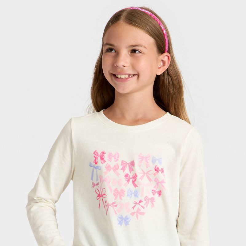 slide 2 of 4, Girls' Long Sleeve 'Bow Heart' Graphic T-Shirt - Cat & Jack™ Cream S, 1 ct