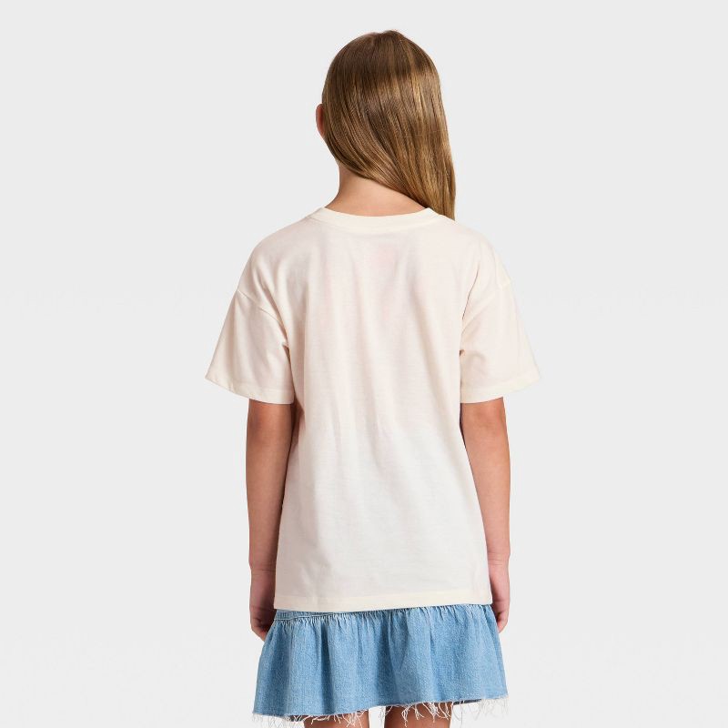 slide 3 of 4, Girls' Short Sleeve 'City Dogs' Oversized Graphic T-Shirt - Cat & Jack™ Cream S, 1 ct