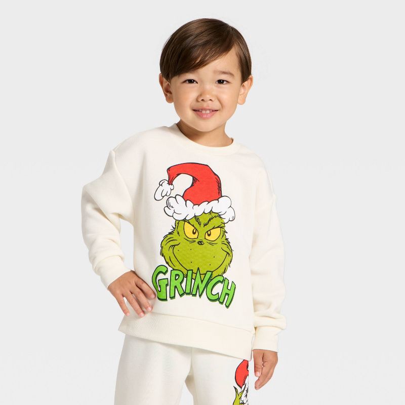 slide 3 of 4, Toddler Boys' 2pc The Grinch Christmas Fleece Sweatshirt and Jogger Set - Cream 12M, 2 ct