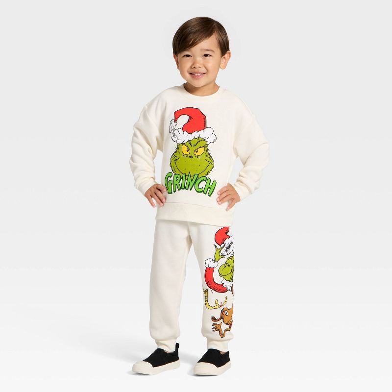 slide 1 of 4, Toddler Boys' 2pc The Grinch Christmas Fleece Sweatshirt and Jogger Set - Cream 4T, 2 ct