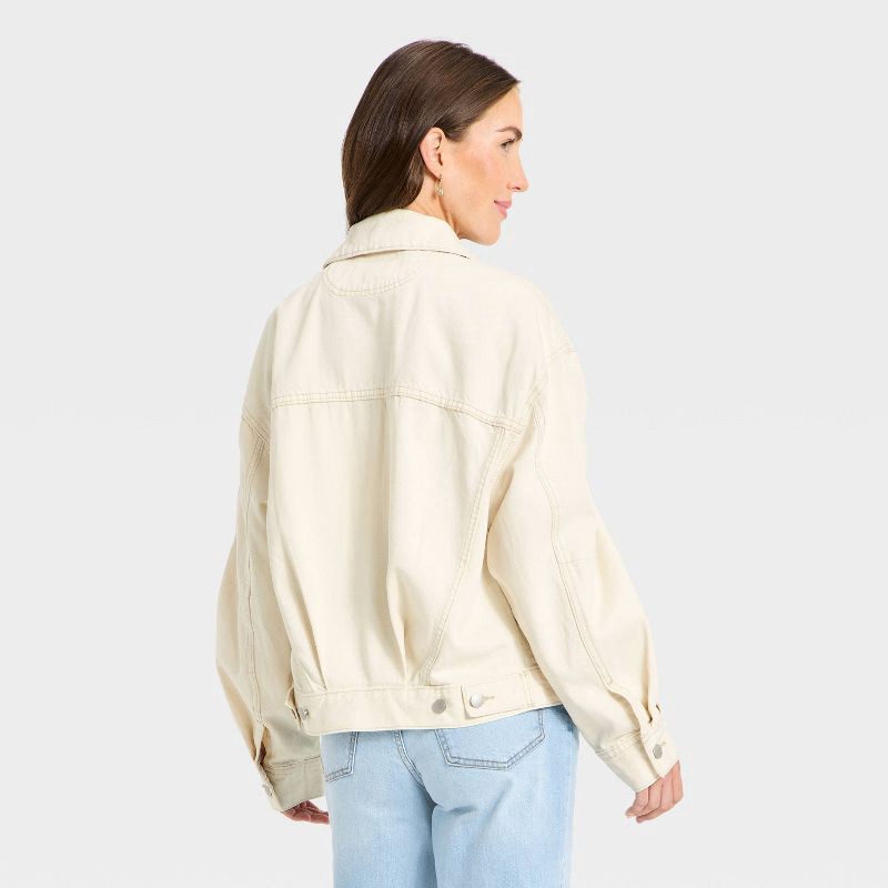 slide 2 of 3, Women's Relaxed Trucker Denim Jacket - Universal Thread™ Off-White L, 1 ct