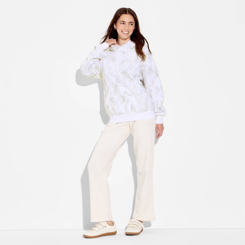 slide 1 of 3, Women's Oversized Graphic Hooded Pullover Sweatshirt - Wild Fable™ Camo M, 1 ct