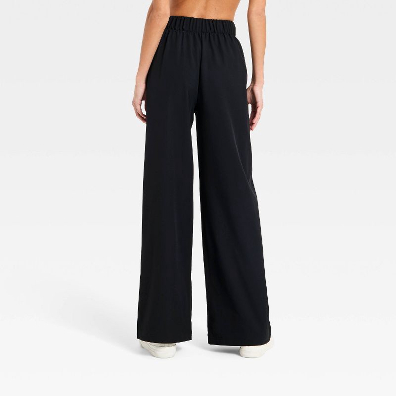 slide 4 of 5, Women's Woven High-Rise Bow Track Pants - All In Motion™ Black S, 1 ct