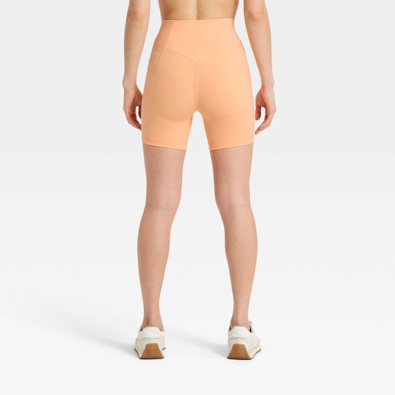 slide 2 of 5, Women's Super Flex High Rise Pocketed Bike Shorts 5" - All in Motion™ Melon Orange XS, 1 ct