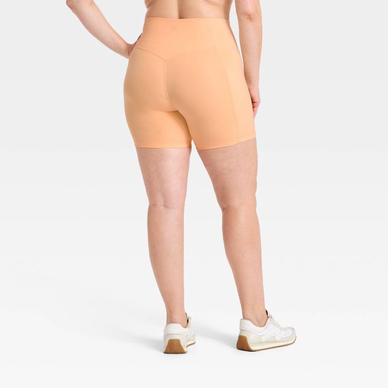 slide 5 of 5, Women's Super Flex High Rise Pocketed Bike Shorts 5" - All in Motion™ Melon Orange XS, 1 ct