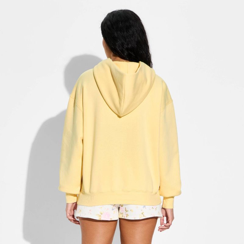 slide 3 of 3, Women's Oversized Hooded Pullover Sweatshirt - Wild Fable™ Light Yellow M, 1 ct
