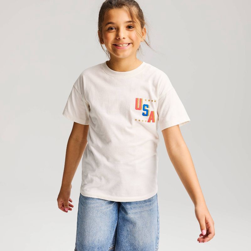 slide 1 of 4, Girls' 4th of July Oversized Short Sleeve 'USA' Graphic Jersey T-Shirt - Cat & Jack™ Cream XL, 1 ct