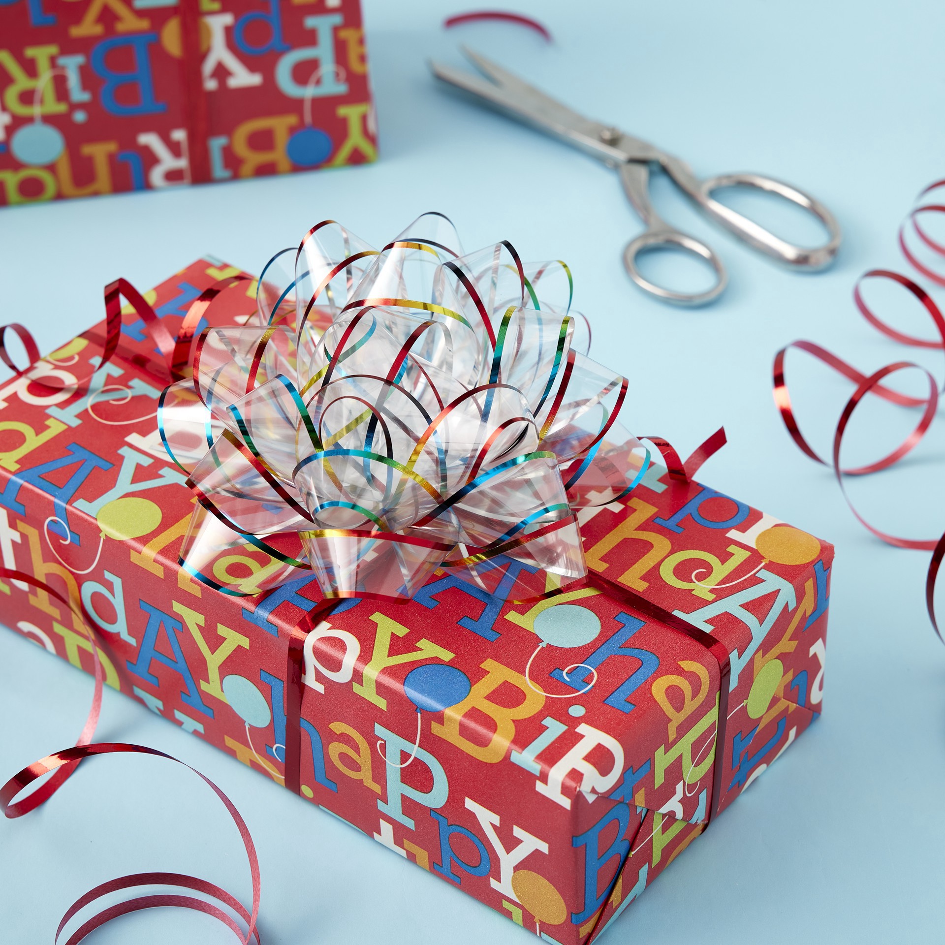 slide 3 of 3, Clear & Rainbow Jumbo Bow By Celebrate It, 6 in