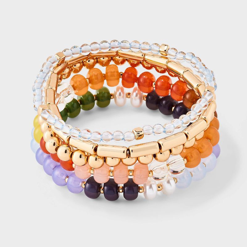 slide 1 of 4, Acrylic Beaded Variety Stretch Bracelet Set 5pc - Universal Thread™ Gold/Purple/pearl, 5 ct