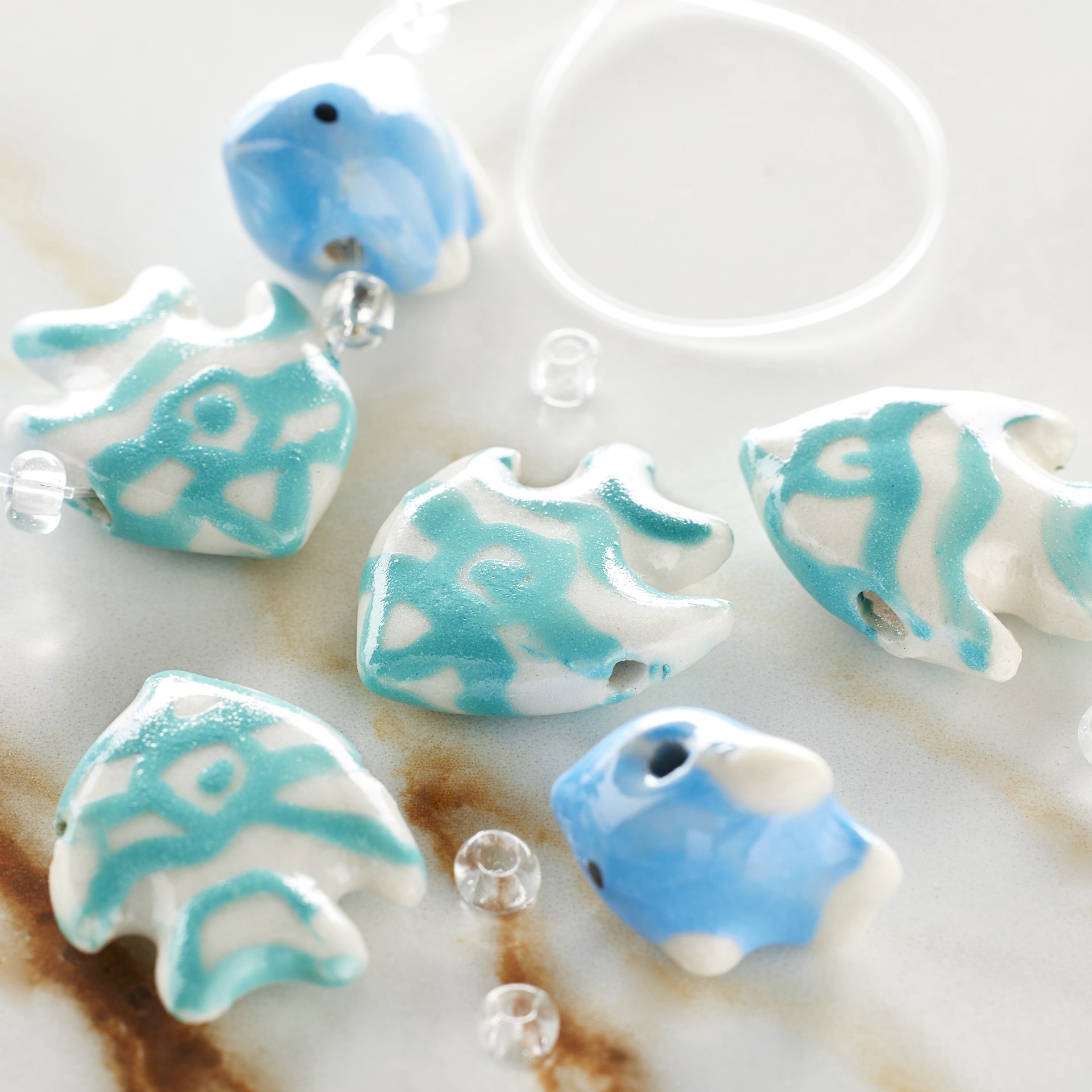 slide 2 of 3, Blue Fish Mix Ceramic Beads By Bead Landing, 22mm x 17mm