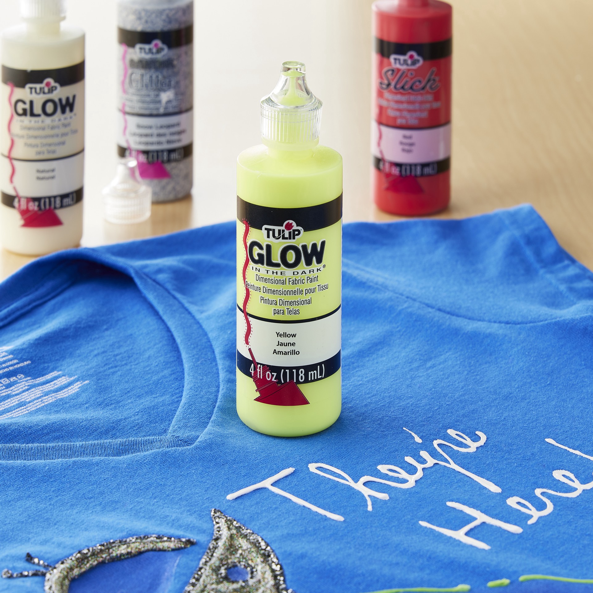 slide 2 of 2, Tulip Glow-In-The-Dark Yellow Dimensional Fabric Paint, 4 fl oz