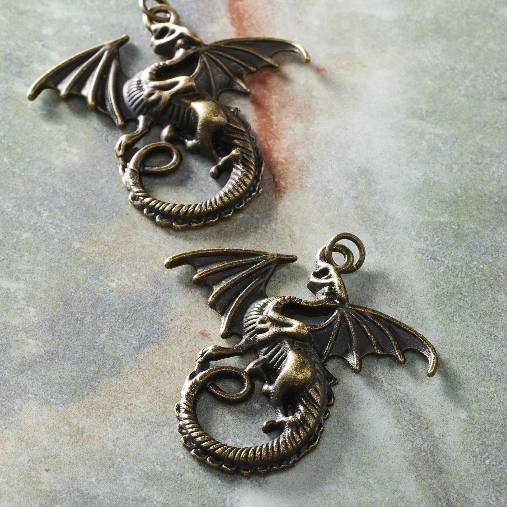 slide 2 of 3, Found Objects Oxidized Brass Dragon Pendants By Bead Landing, 1.77 in x 1.69 in x 0.19 in