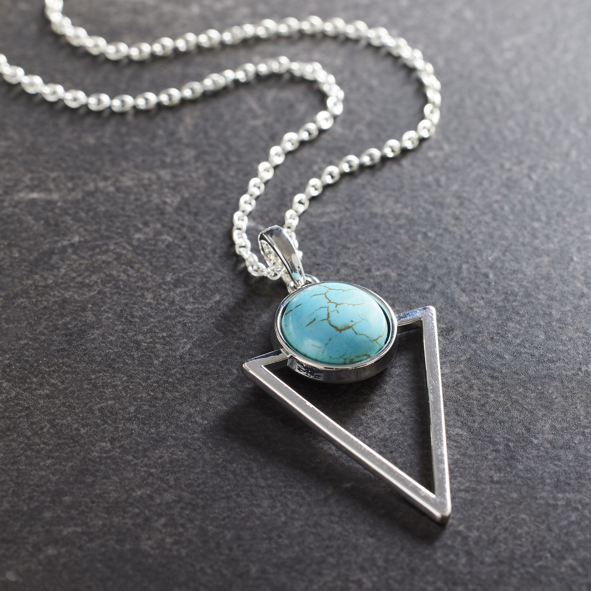 slide 2 of 3, Dyed Turquoise Howlite Triangle Pendant By Bead Landing, 27 mm