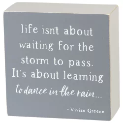 Life isn't about waiting for the storm to pass, it's about learning to dance in the rain box sign