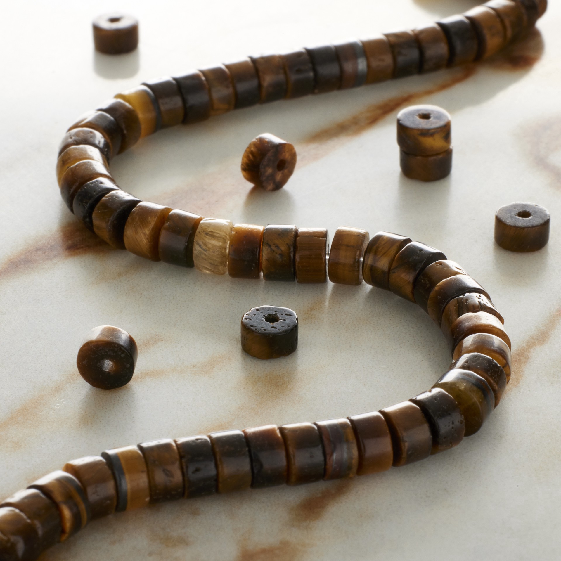 slide 2 of 3, Tiger's Eye Heishi Beads By Bead Landing, 4 mm