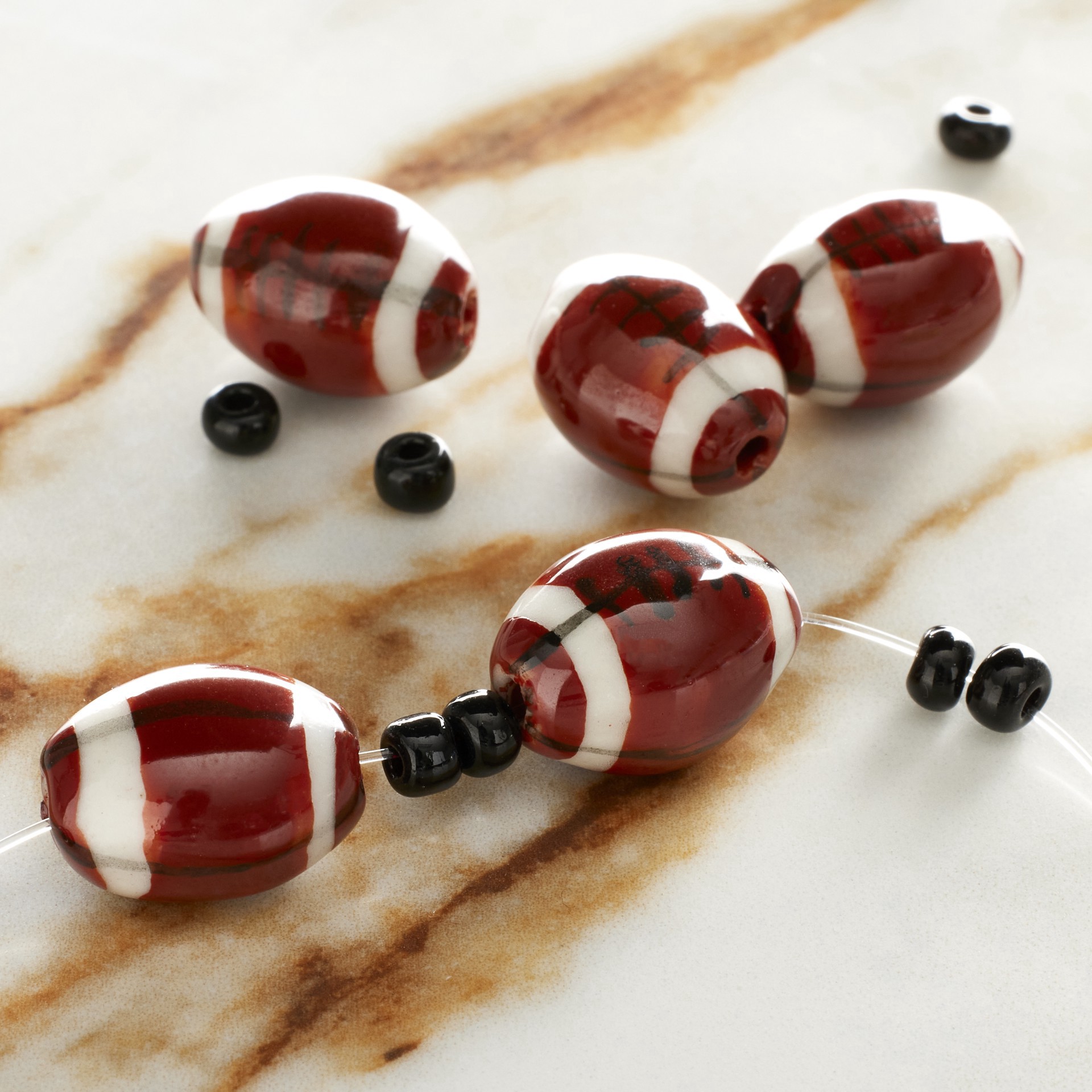 slide 3 of 5, Ceramic Football Beads, 15mm By Bead Landing, 15mm