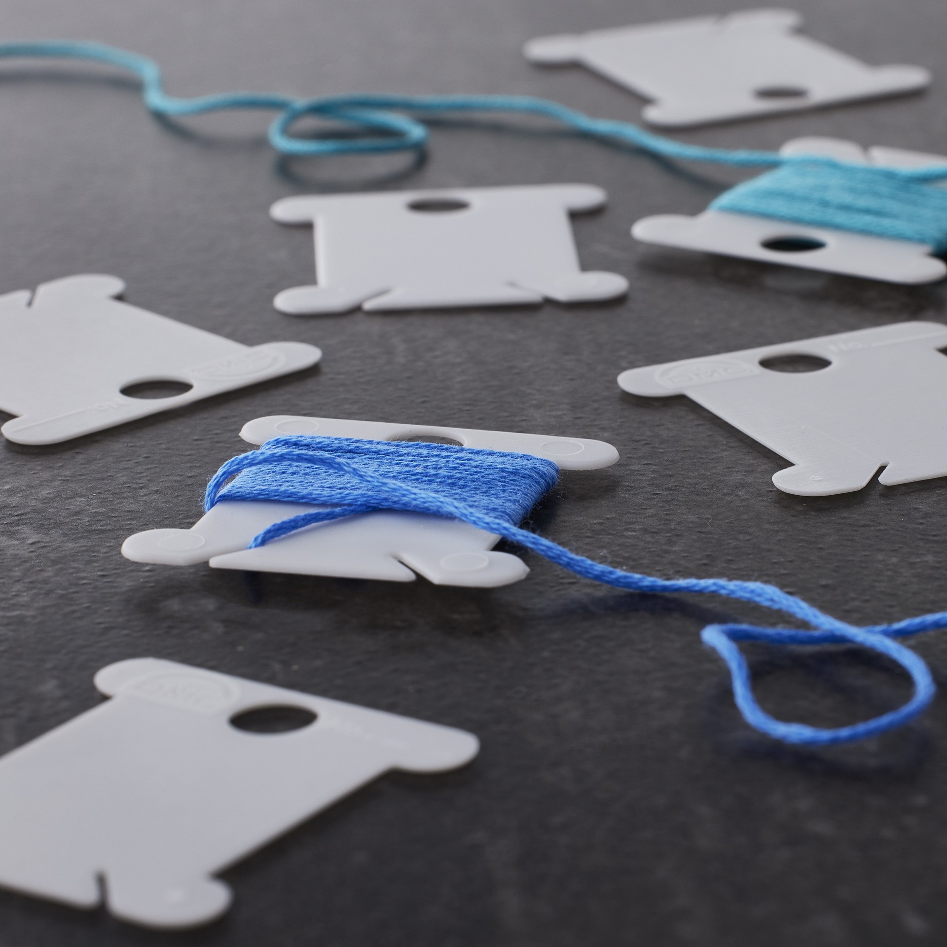 slide 3 of 3, The Dmc Corporation Dmc Plastic Bobbins, 1 ct