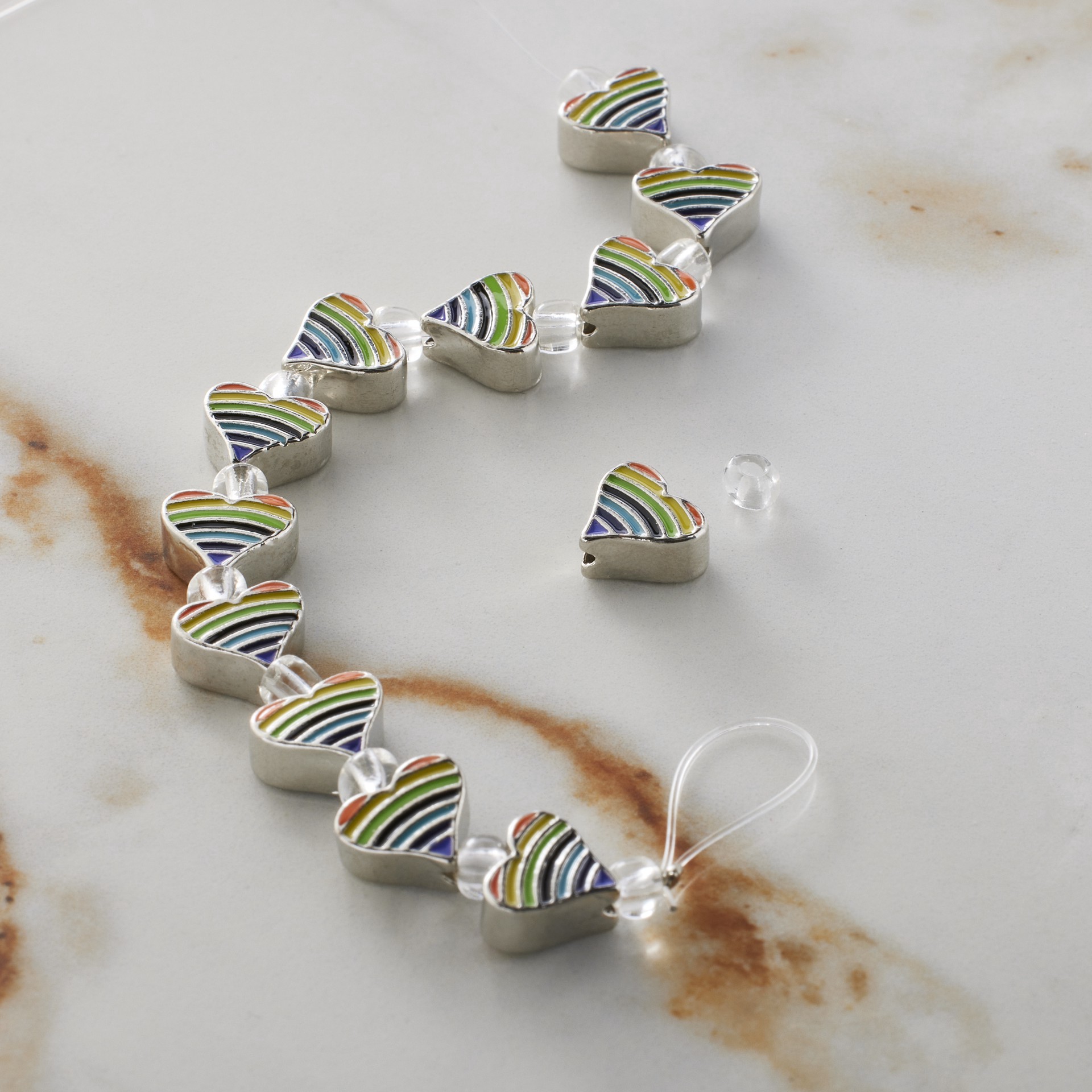 slide 3 of 3, Rainbow Stripe & Rhodium Heart Beads, 9mm By Bead Landing, 9 mm